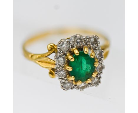 An emerald and diamond cluster ring, set in yellow gold, size P, hallmark rubbed.