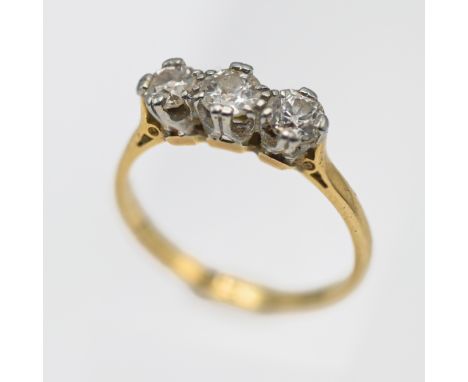 An 18ct yellow gold and diamond three stone ring, size N.