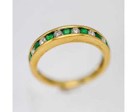An 18ct yellow gold emerald and diamond half eternity ring, size Q.