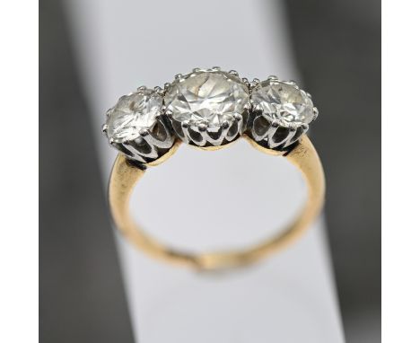An impressive diamond three stone ring, old brilliant cut diamonds with a total weight approx 4.25 carats, set in 18ct yellow
