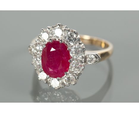 EIGHTEEN CARAT GOLD RUBY AND DIAMOND CLUSTER RING
the central oval ruby 9x7.5mm surrounded by diamonds totalling approximatel