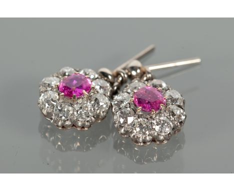 PAIR OF EDWARDIAN RUBY AND DIAMOND CLUSTER EARRINGS
each formed by a daisy cluster motif with central round ruby surrounded b