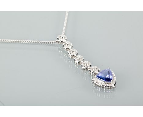 TANZANITE AND DIAMOND NECKLACE
with a large trilliant cut tanzanite of approximately 3.84 carats, surrounded by round diamond