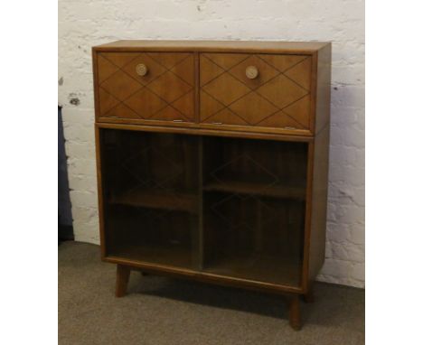 A light oak retro twin compartment bureau with cocktail facility and glass sliding doors.