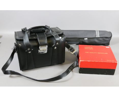 A collection of vintage photographic equipment to include a Praktica LT3 35mm camera, a Zenit II 35mm camera, lenses, carry b