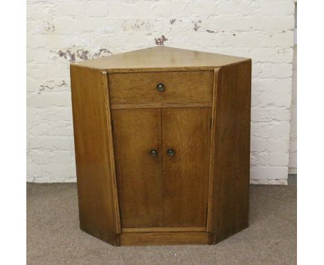 A light oak corner cupboard.