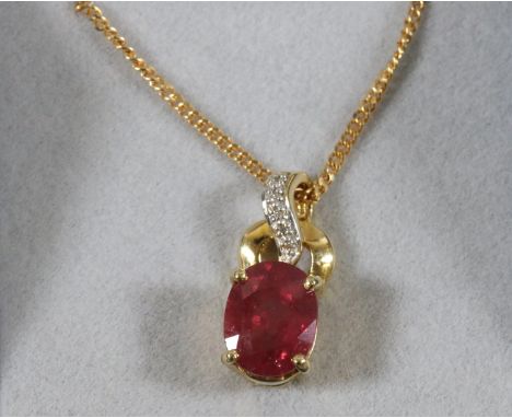 A ladies 9 carat gold necklace with yellow metal pendant set with a synthetic ruby and diamonds.
