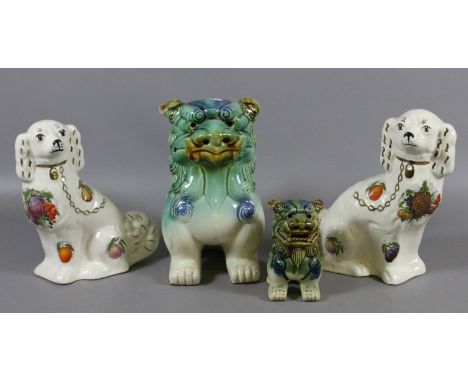 Two ceramic Chinese dogs of fo along with a pair of pottery mantel dogs.
