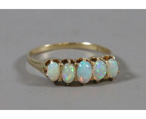 A gold five stone opal ring, size Q1/2.