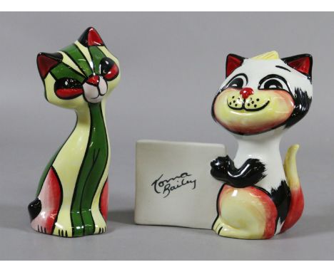 A Lorna Bailey model of a cat 'Miss Prim' along with another cat holding a sign.