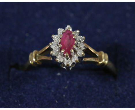 A 9 carat gold ruby and diamond oval cluster ring. Size K, 1.4 grams.