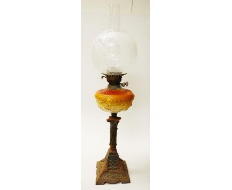 Antique decorated cast iron based banquet lamp decorated cast iron base, supporting decorated amber glass reservoir, to doubl