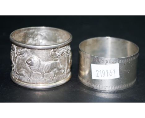 Decorated Oriental silver napkin ring embossed jungle decoration,(NOT Monogrammed); together with an unmarked silvered napkin