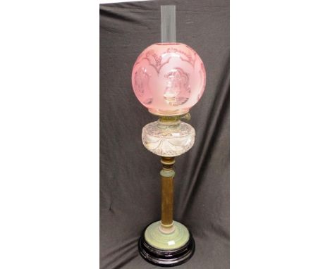 Antique kerosene brass banquet lamp with brass column on glass base, clear cut glass reservoir and etched ruby glass shade, W