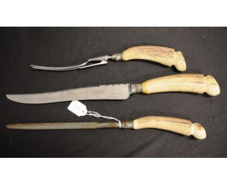 Vintage antler handle carving set including: carving knife and fork, and steel, marked for Hardy Brothers.