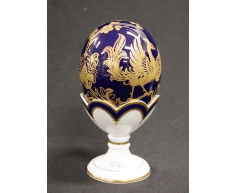 Royal Crown Derby egg form decorated piece blue ceramic gilt decorated egg, gold button to base, in fitted white ceramic stan