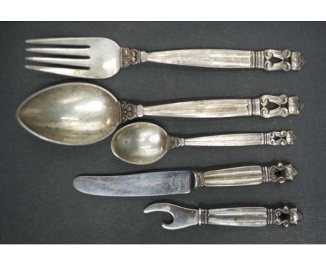Five pieces Georg Jensen acorn silver cutlery including: dessert spoon, and matching fork, and coffee spoon, each marked ster