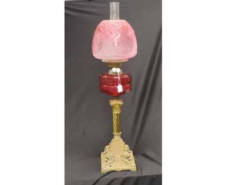 Antique cast iron based ruby glass banquet lamp decorated cast iron base, to decorated column, supporting a ruby glass reserv