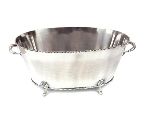 A silver plated twin handled champagne bucket, raised on four lion mask paw feet