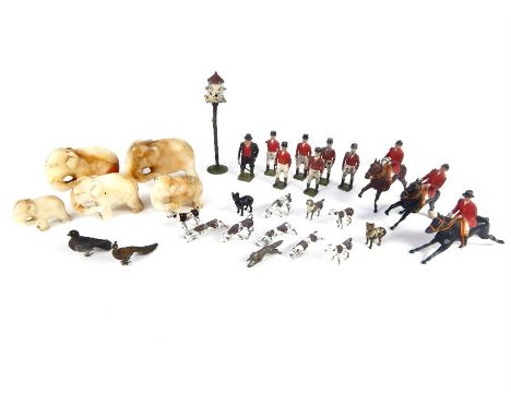 A set of painted lead Britain's of London fox hunting figures, with a graduated set of five eastern carved soapstone elephant