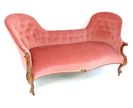 French late Napoleon III walnut frame conversation sofa, scroll arms, leaf carving, cabriole legs, brass castors, later butto