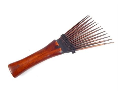 An African or Oceanic tribal comb, with plain mahogany handle, 21cm long.