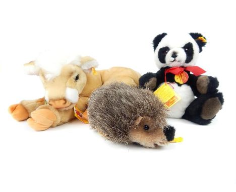 A group of three mid 20th century Steiff soft toys; Panda, Hedgehog and Cow, all complete with lablels.