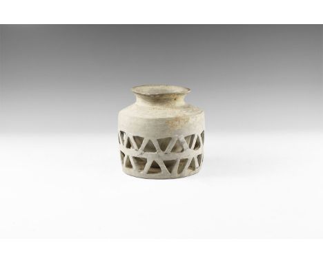 3rd-2nd millennium BC. A ceramic vessel with flared rim and globular body encased in a drum-shaped, separately-made outer ves