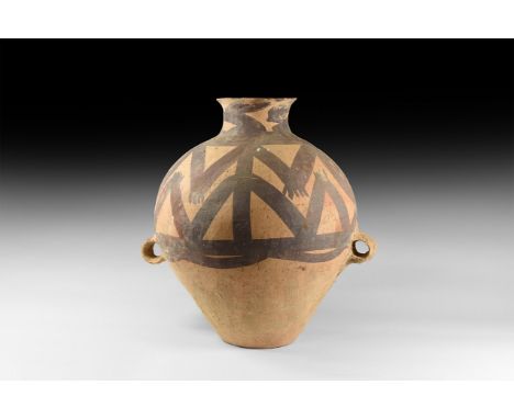 3rd millennium BC. A bulbous ceramic jar with two small loop handles, narrow base and trumpet-shaped mouth; decorated to the 