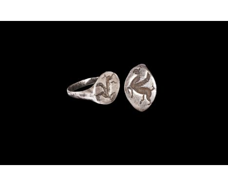 5th century BC. A silver finger ring with D-section hoop supporting a scaphoid bezel with intaglio gryphon motif. Cf. Chadour