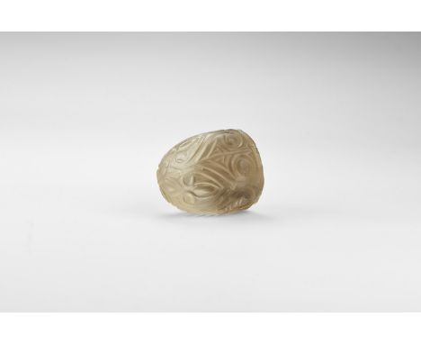 18th-19th century AD. A light brown smoky quartz plano-convex gaming piece with carved design of heart-shaped foliage. 85 gra