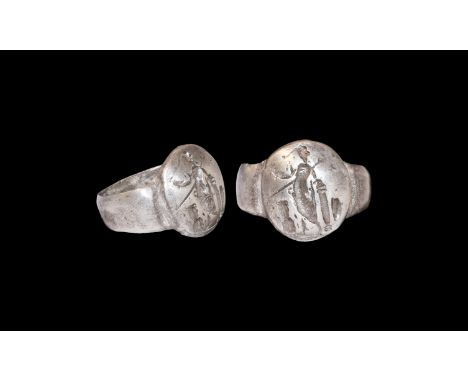 3rd-4th century AD. A silver finger ring comprising a tapering D-section hoop, convex discoid plaque with standing figure of 