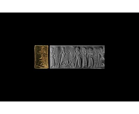 1900-1530 BC. A serpentinite cylinder seal with frieze and cuneiform inscription, the god Nergal holding in his raised left h