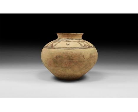 2nd millennium BC. A ceramic jar with squat body, narrow base, short neck and flared rim; band of black painted decoration to