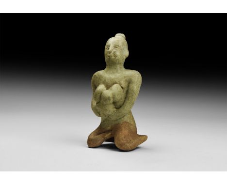 14th-16th century AD. A green-glazed ceramic figurine of a nude seated female suckling a baby in her arms. 175 grams, 10.5cm 