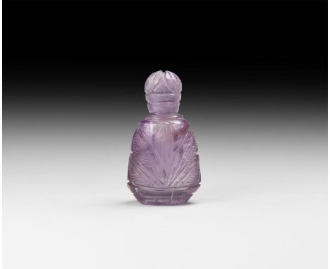 19th century AD. A carved amethyst bottle and stopper with foliage motifs to the broad faces. 34 grams, 52mm (2"). Property o