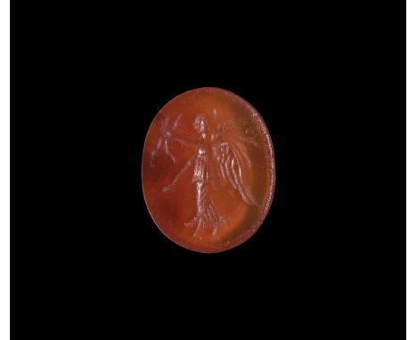 1st-3rd century AD. A discoid carnelian cloison with intaglio winged Victory, wreath in her extended hands. 0.59 grams, 13mm 