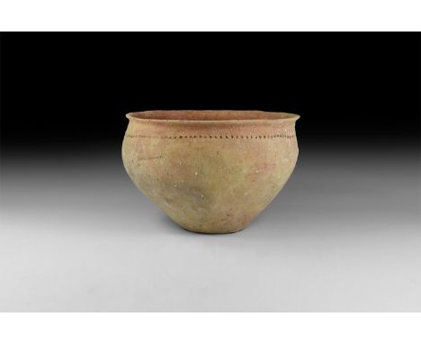 16th-14th century BC. A ceramic coarse ware bowl with rolled rim, series of impressed dots between rim and shoulder. 960 gram