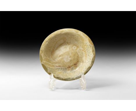 10th-11th century AD. A ceramic bowl with slightly flared rim, decorated to the inside with a large guinea fowl in ochre colo