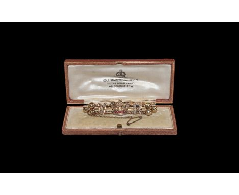 19th century AD. A gold bar brooch by Collingwood (Jewellers) Ltd of London with double twisted bars supporting initials V an