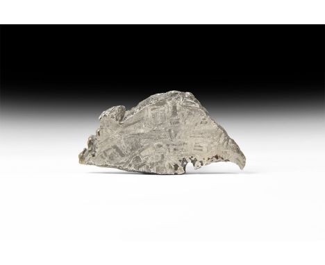 A polished and etched slice of the Seymchan Meteorite, the cut surface showing the distinctive and unusually distorted Widman