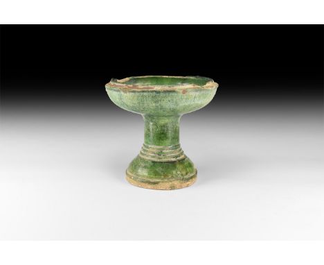 Ming Dynasty, 1368-1644 AD. A ceramic green glazed celadon ware lamp in the form of a chalice, with wide bowl, lipped rim; wi