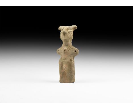 Neolithic, 6th-4th millennium BC. A ceramic figurine of a standing male with prominent horned headdress and nose, stub arms e