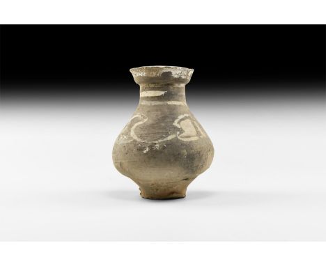 Han Dynasty, 206 BC-220 AD. A small ceramic vase with flared rim, short neck and globular body decorated with geometric patte