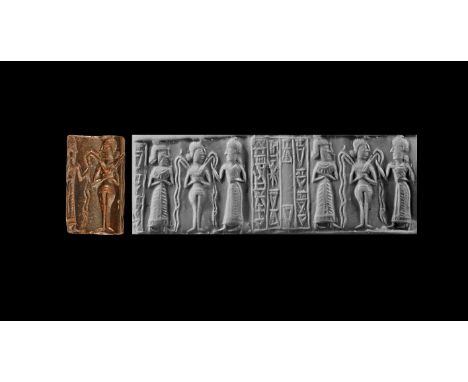 19th-17th century BC. A haematite cylinder seal with a nude goddess with topknot hairstyle, looking to the right, holds in fr