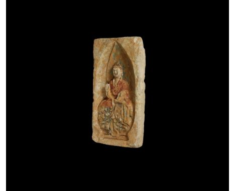 Northern Wei Dynasty, 386-534 AD. A ceramic rectangular brick with Buddha seated in a niche with pointed nimbus to the back o