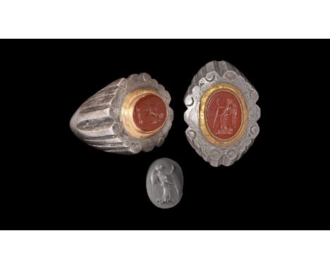 3rd century AD. A substantial silver finger ring with D-section tapering hoop, ribbed shoulders, ellipsoid plaque with scroll