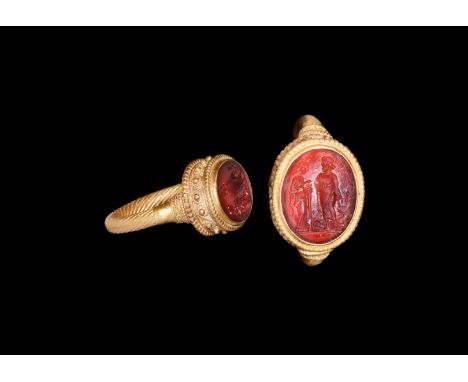 1st century BC-1st century AD. A gold finger ring comprising a spiral-wound wire tubular hoop with beaded wire collars, disco