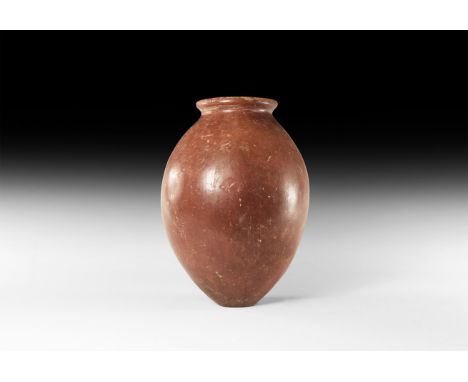 Naqada II Period, 3650-3300 BC. A ceramic polished red ware jar with rolled rim, short neck and globular body with small flat