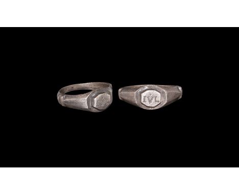 3rd century AD. A silver finger ring with D-section hoop, transverse ledges to the facetted shoulders, ellipsoid plaque with 